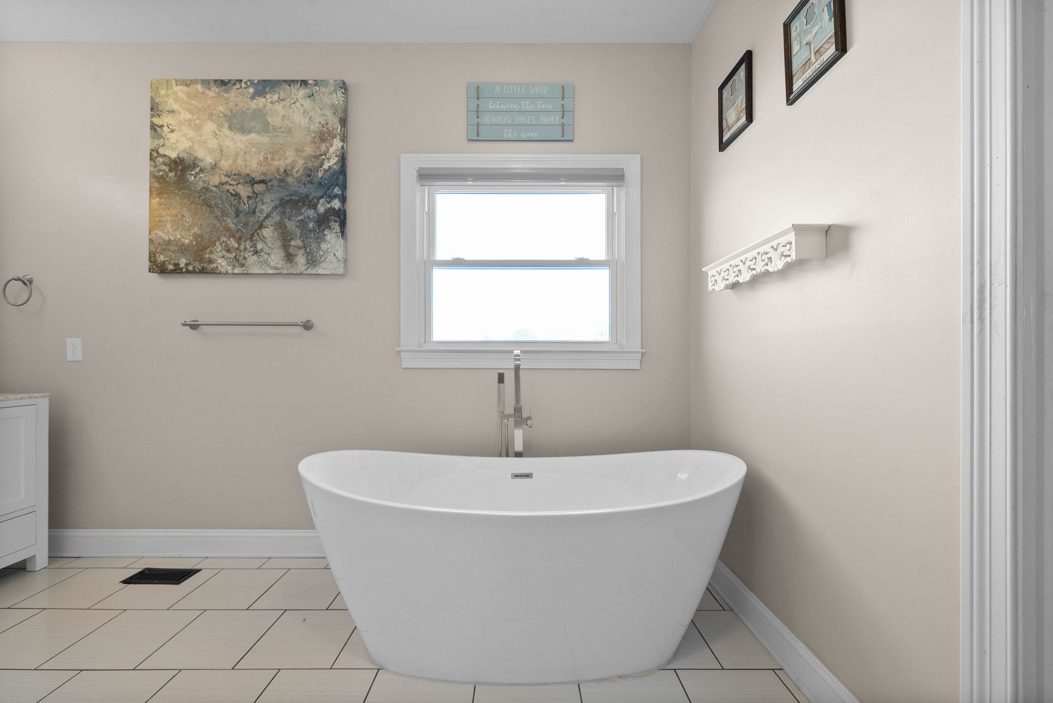 4787 Sango Road Clarksville, TN 37043 - Photo 27 of 55 a white bath tub sitting in a bathroom next to a window