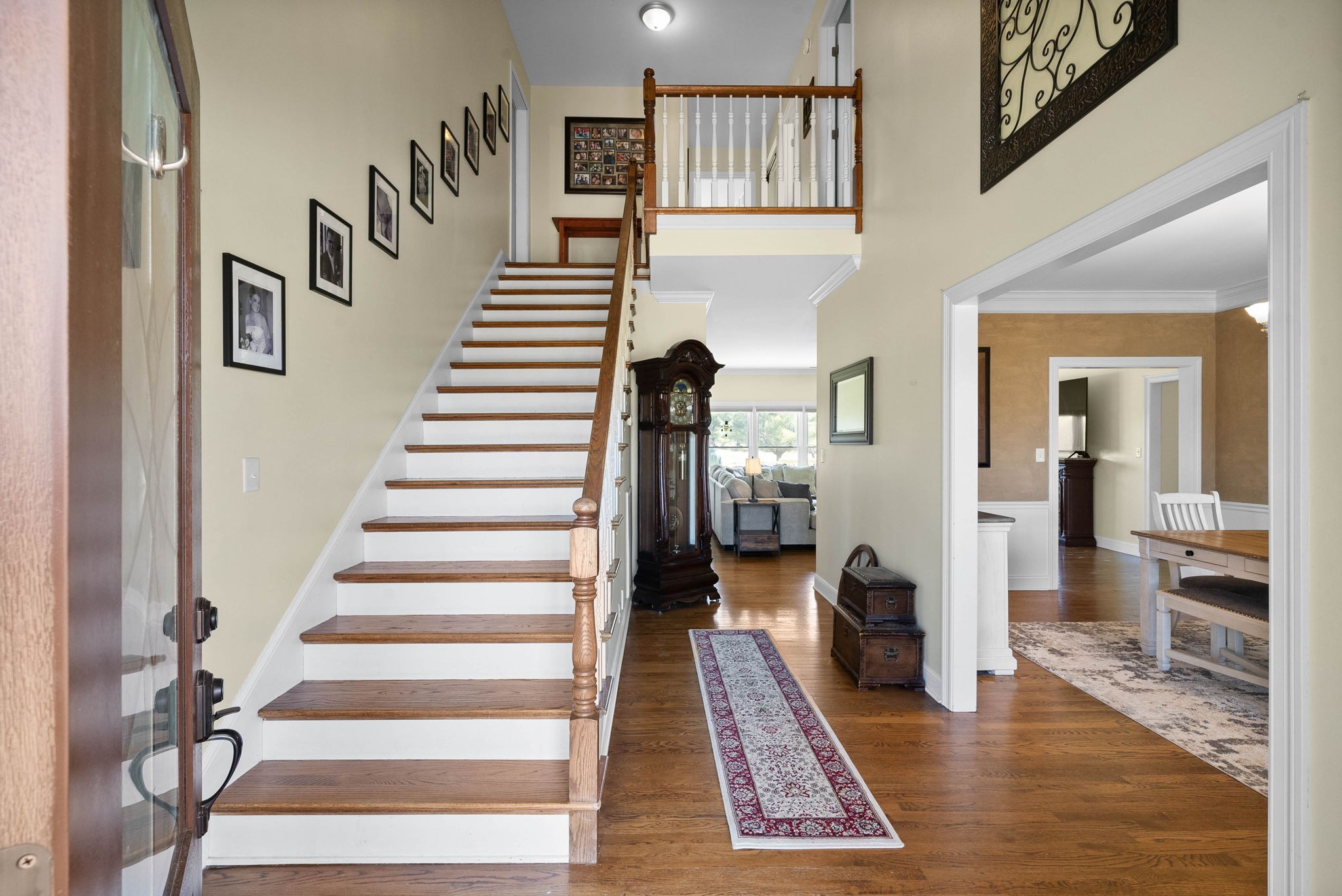 4787 Sango Road Clarksville, TN 37043 - Photo 8 of 55 a view of staircase with lots of frames on wall and wooden floor