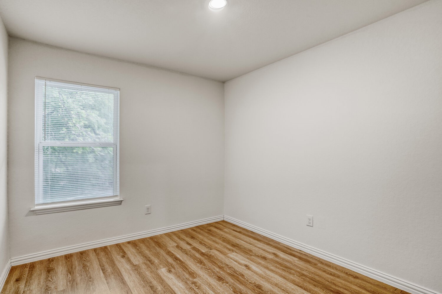 5626 Simsdale Street Houston, TX 77033 - Photo 4 of 10 a view of an empty room with a window