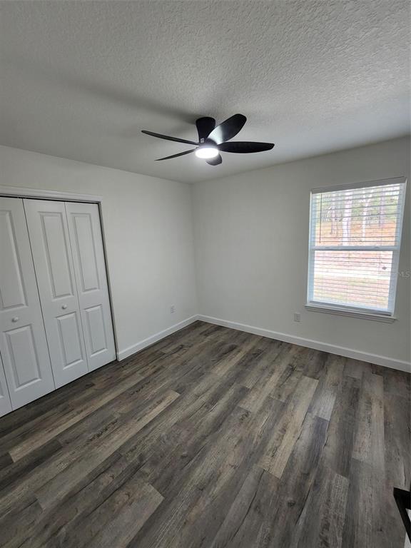 820 Redwood Road Dunnellon, FL 34431 - Photo 13 of 28 a view of empty room with wooden floor and fan