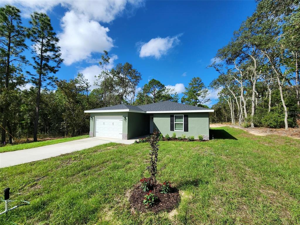 820 Redwood Road Dunnellon, FL 34431 - Photo 2 of 28 a house view with a garden space