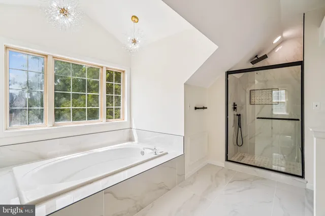 a bathroom with a bathtub and a shower