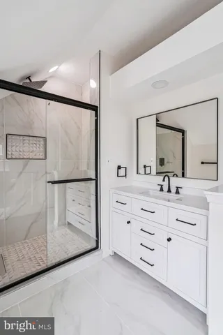 a bathroom with a double vanity sink a mirror and shower