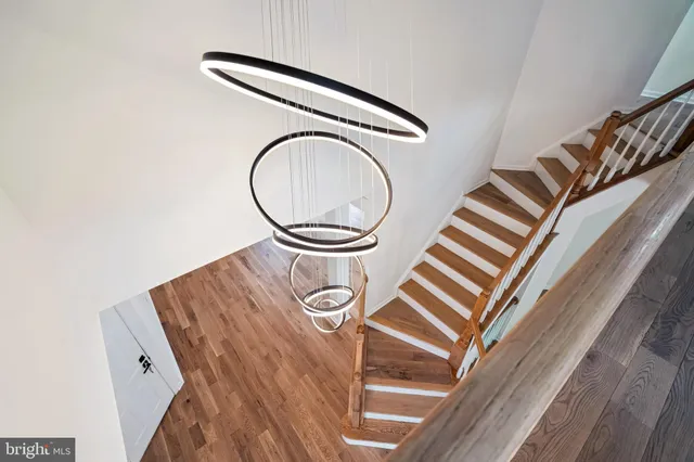 a view of a room with wooden floor and white walls