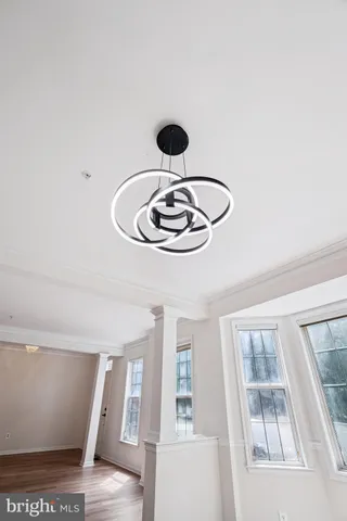 a close view of dining table chairs wooden floor and a chandelier