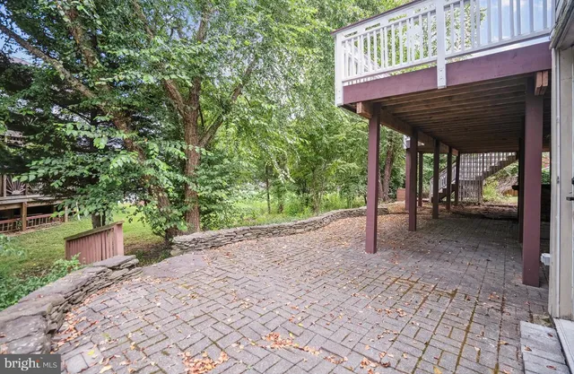 a view of a patio with a table and chairs under an umbrella