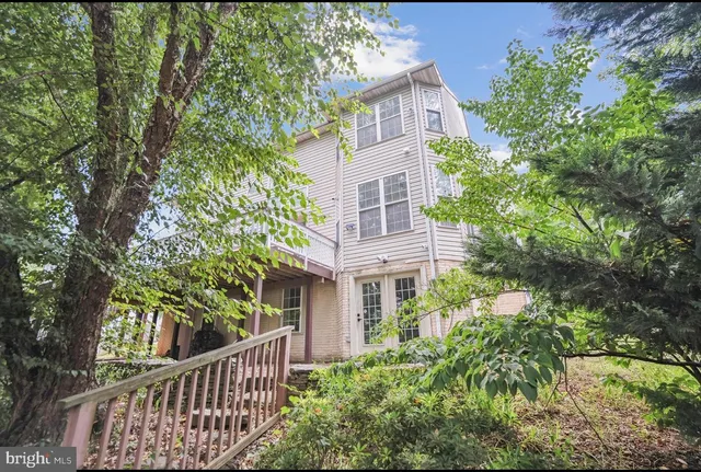 front view of a house with a tree
