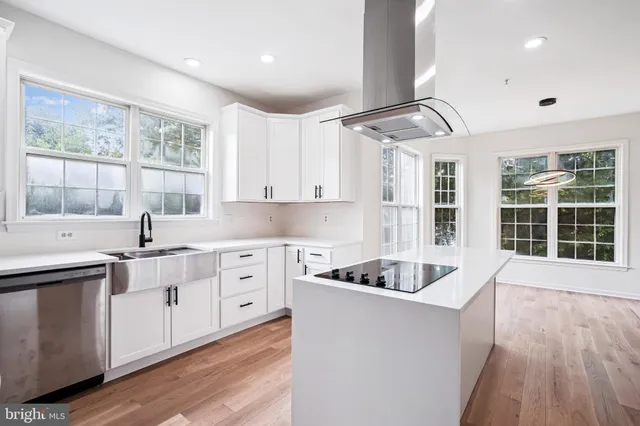 a kitchen with cabinets a sink and wooden floor