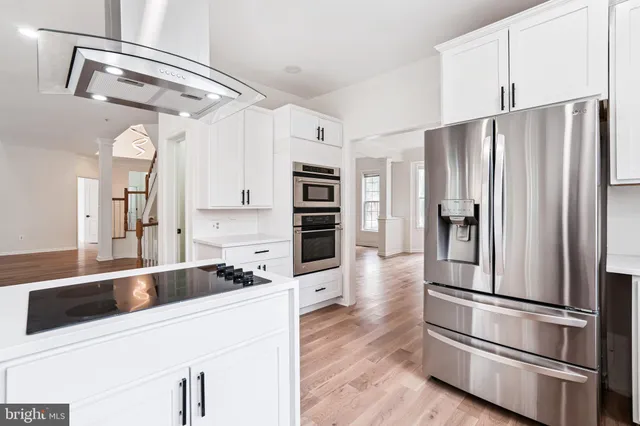 a kitchen with stainless steel appliances and refrigerator