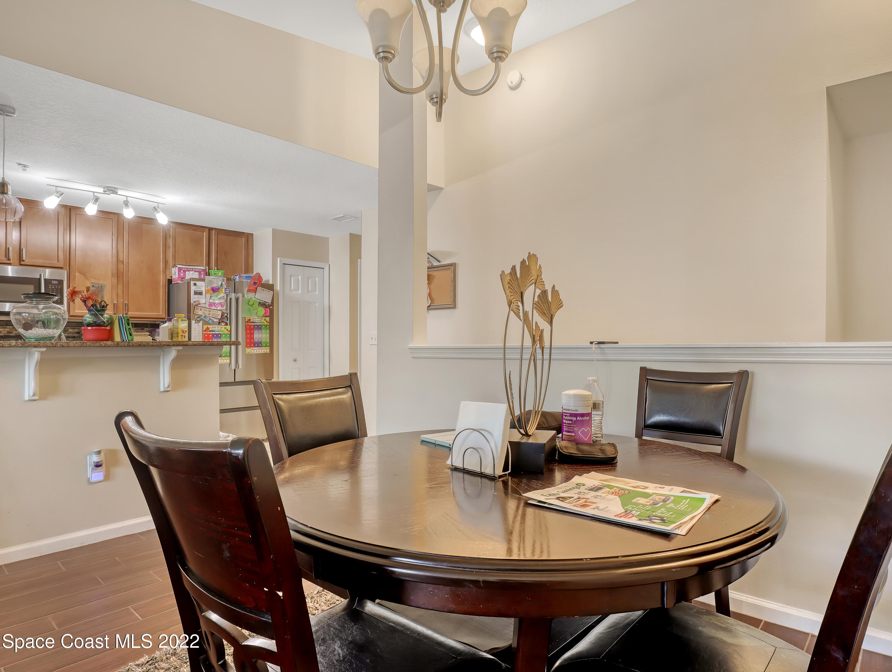 4066 Meander Place, Unit 203 Rockledge, FL 32955 - Photo 12 of 21 a dining room with furniture and wooden floor