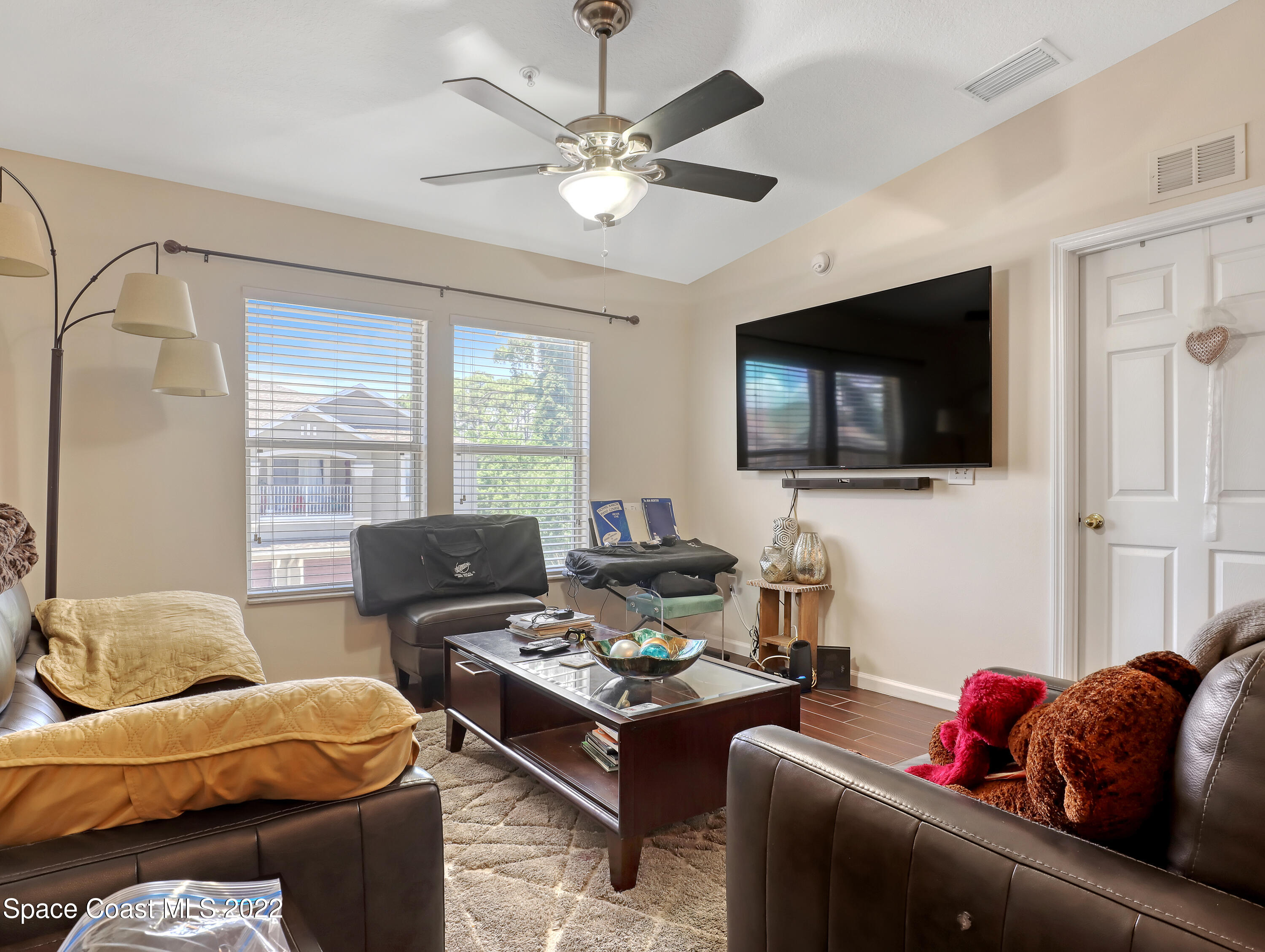 4066 Meander Place, Unit 203 Rockledge, FL 32955 - Photo 9 of 21 a living room with furniture and a flat screen tv
