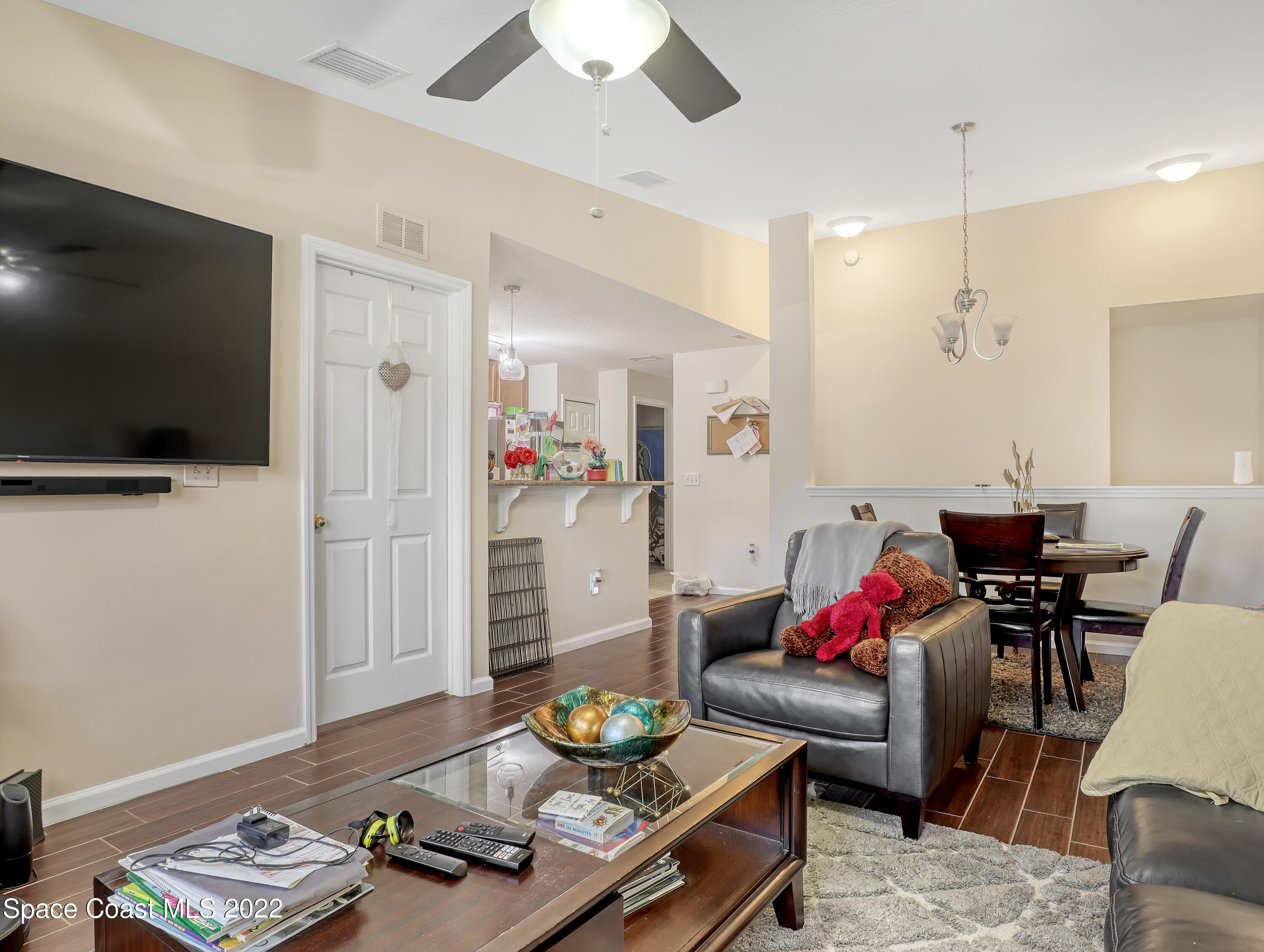 4066 Meander Place, Unit 203 Rockledge, FL 32955 - Photo 10 of 21 a living room with furniture and a flat screen tv
