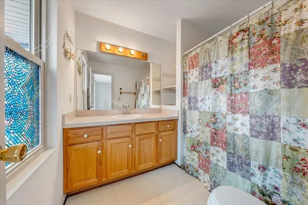 a spacious bathroom with a sink mirror vanity and toilet