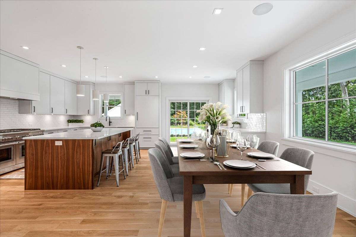 36 Jagger Lane Westhampton, NY 11977 - Photo 13 of 41 a kitchen with a dining table chairs and stove