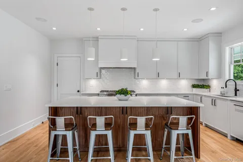 a kitchen with a white cabinets and appliances