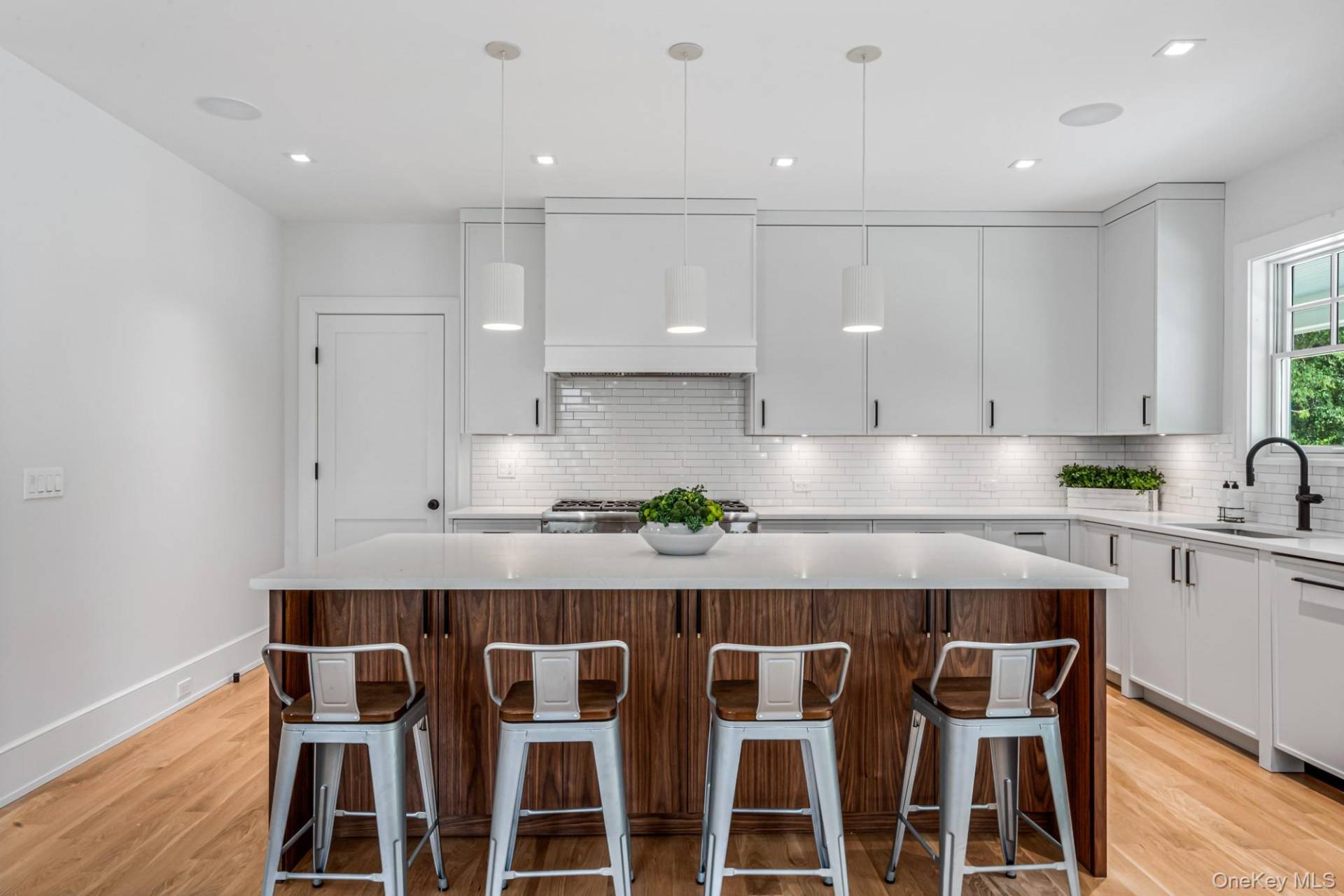 36 Jagger Lane Westhampton, NY 11977 - Photo 14 of 41 a kitchen with granite countertop white cabinets stainless steel appliances and wooden floor