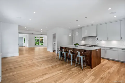 a kitchen with stainless steel appliances granite countertop a stove a sink a refrigerator and a microwave