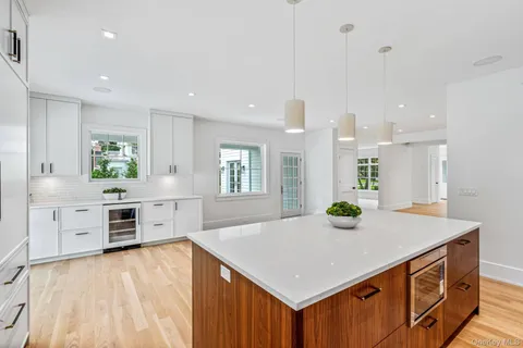 a kitchen with stainless steel appliances granite countertop a stove a sink a refrigerator and a microwave