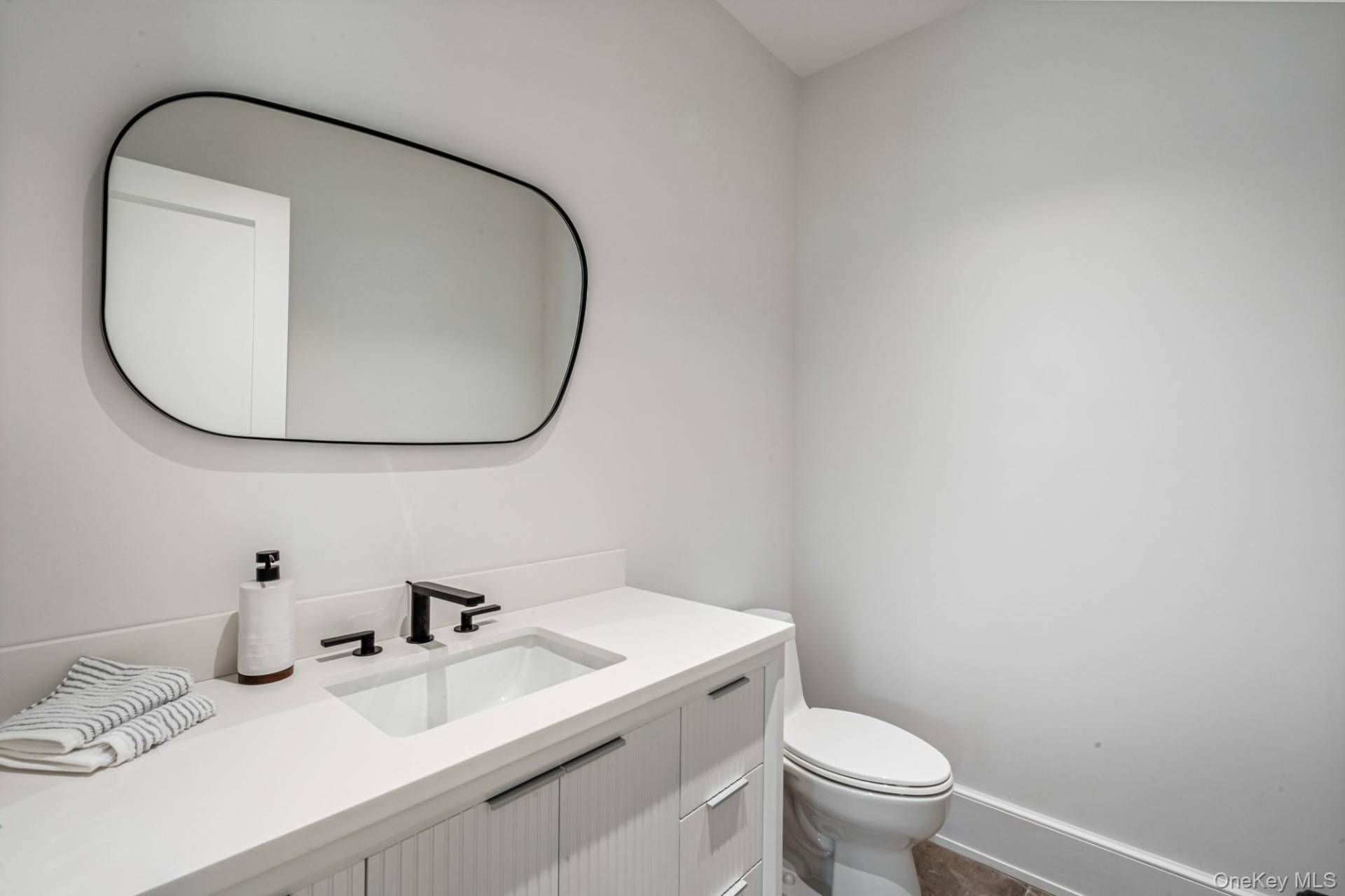 36 Jagger Lane Westhampton, NY 11977 - Photo 18 of 41 a bathroom with a sink and a mirror