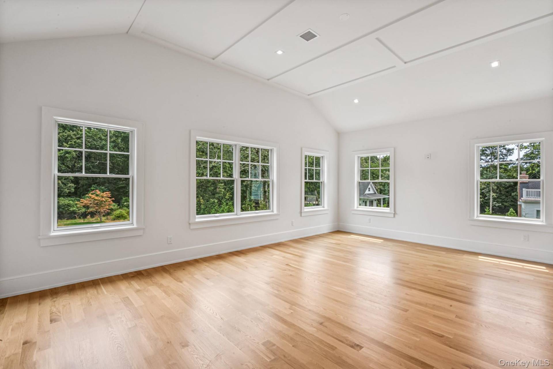 36 Jagger Lane Westhampton, NY 11977 - Photo 20 of 41 an empty room with wooden floor and windows