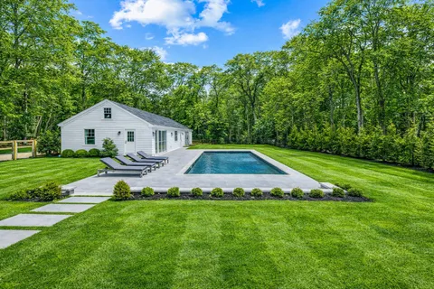 a view of house with backyard and garden
