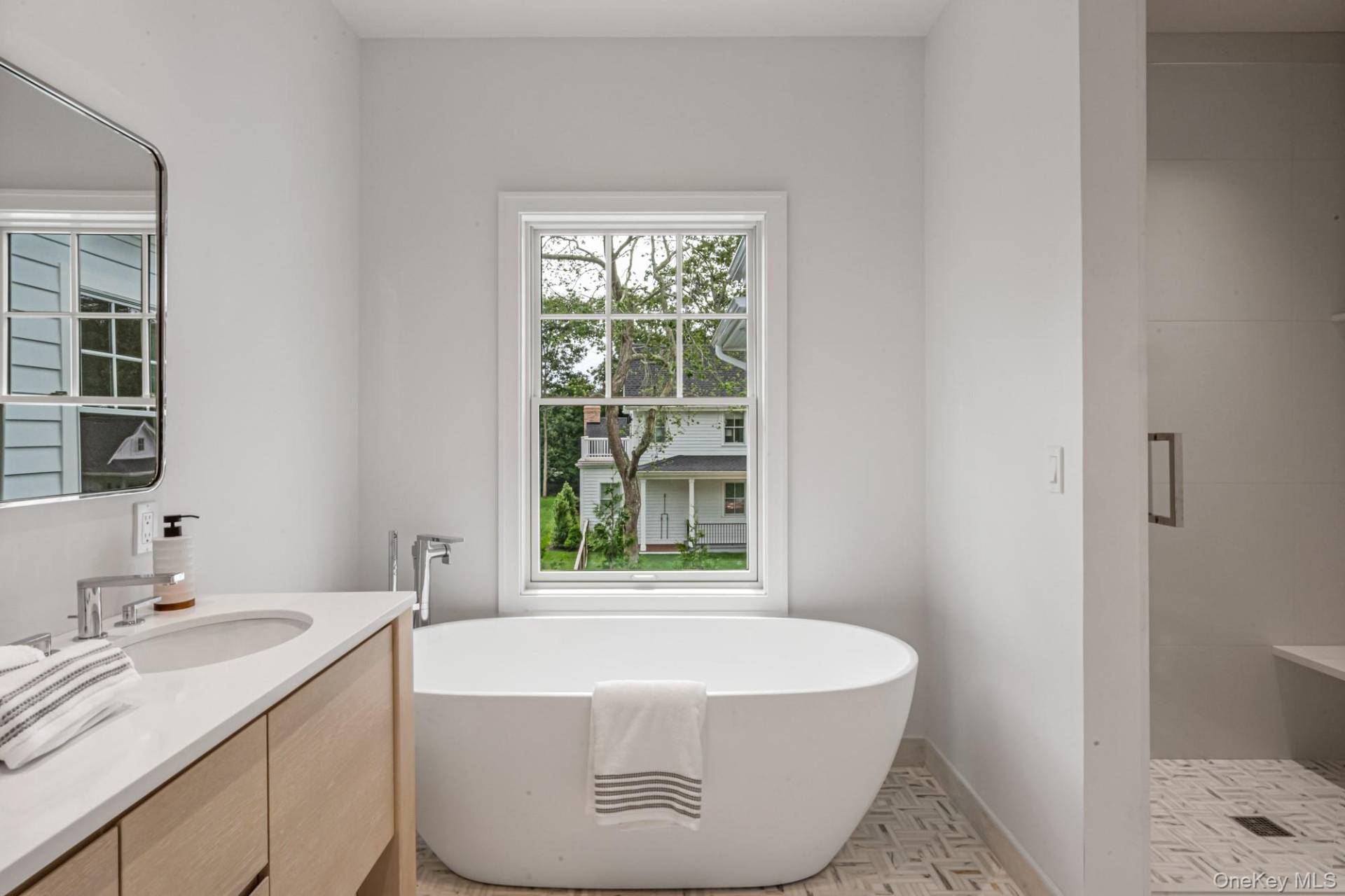 36 Jagger Lane Westhampton, NY 11977 - Photo 23 of 41 a bathroom with a granite countertop sink and a bathtub