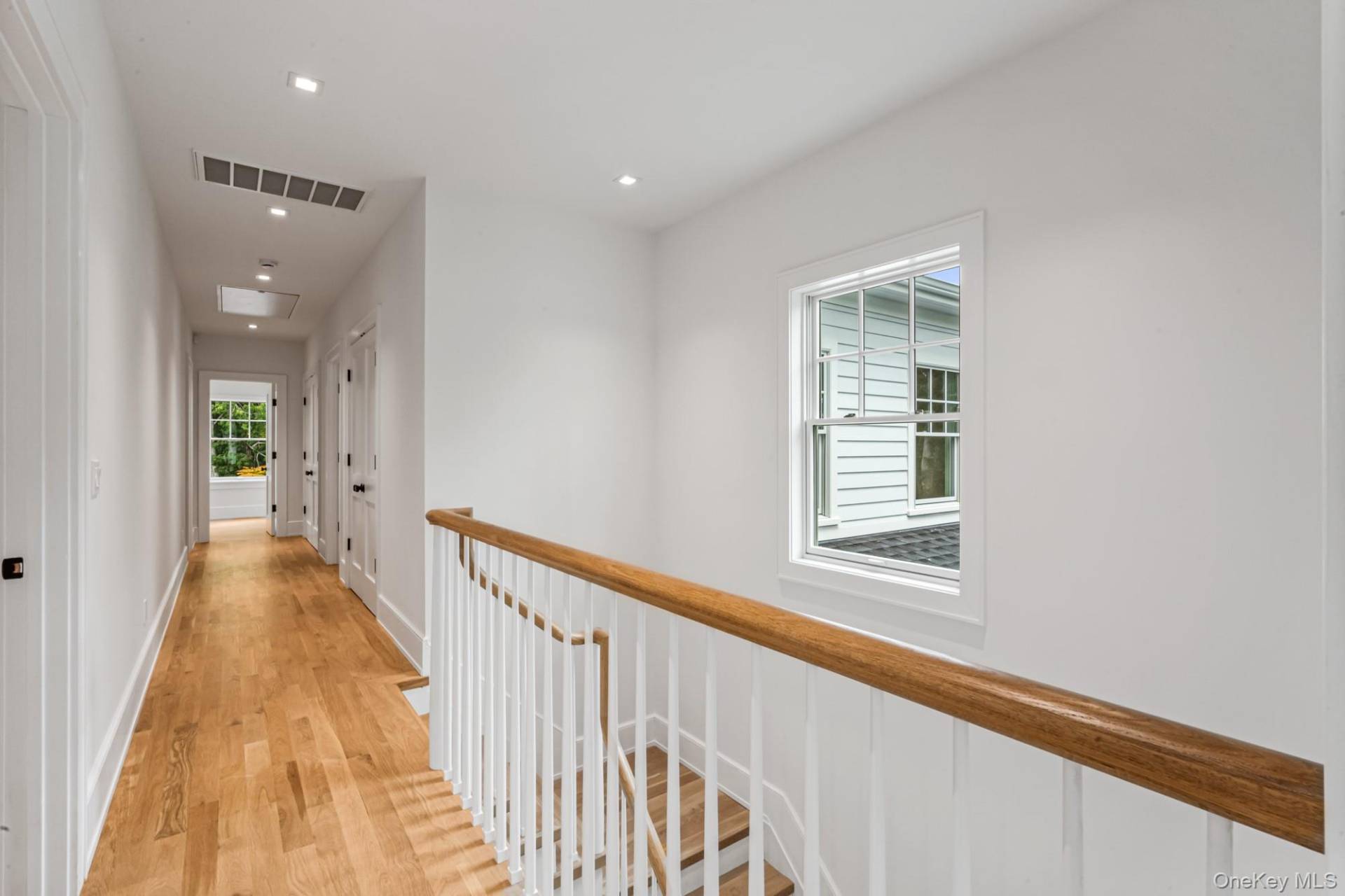 36 Jagger Lane Westhampton, NY 11977 - Photo 28 of 41 a view of a hallway with wooden floor and staircase