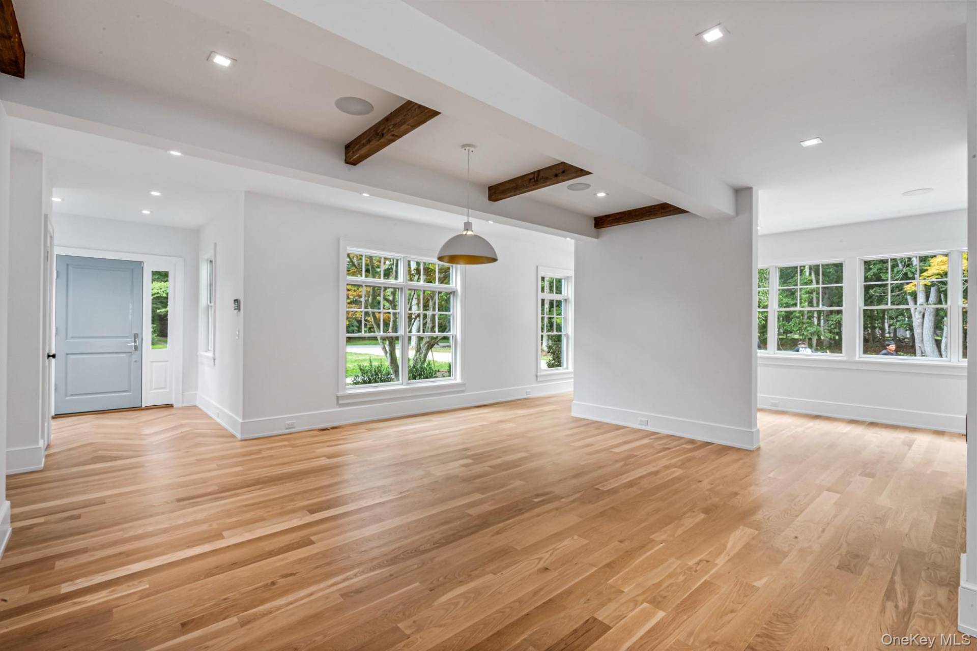36 Jagger Lane Westhampton, NY 11977 - Photo 3 of 41 an empty room with wooden floor and windows