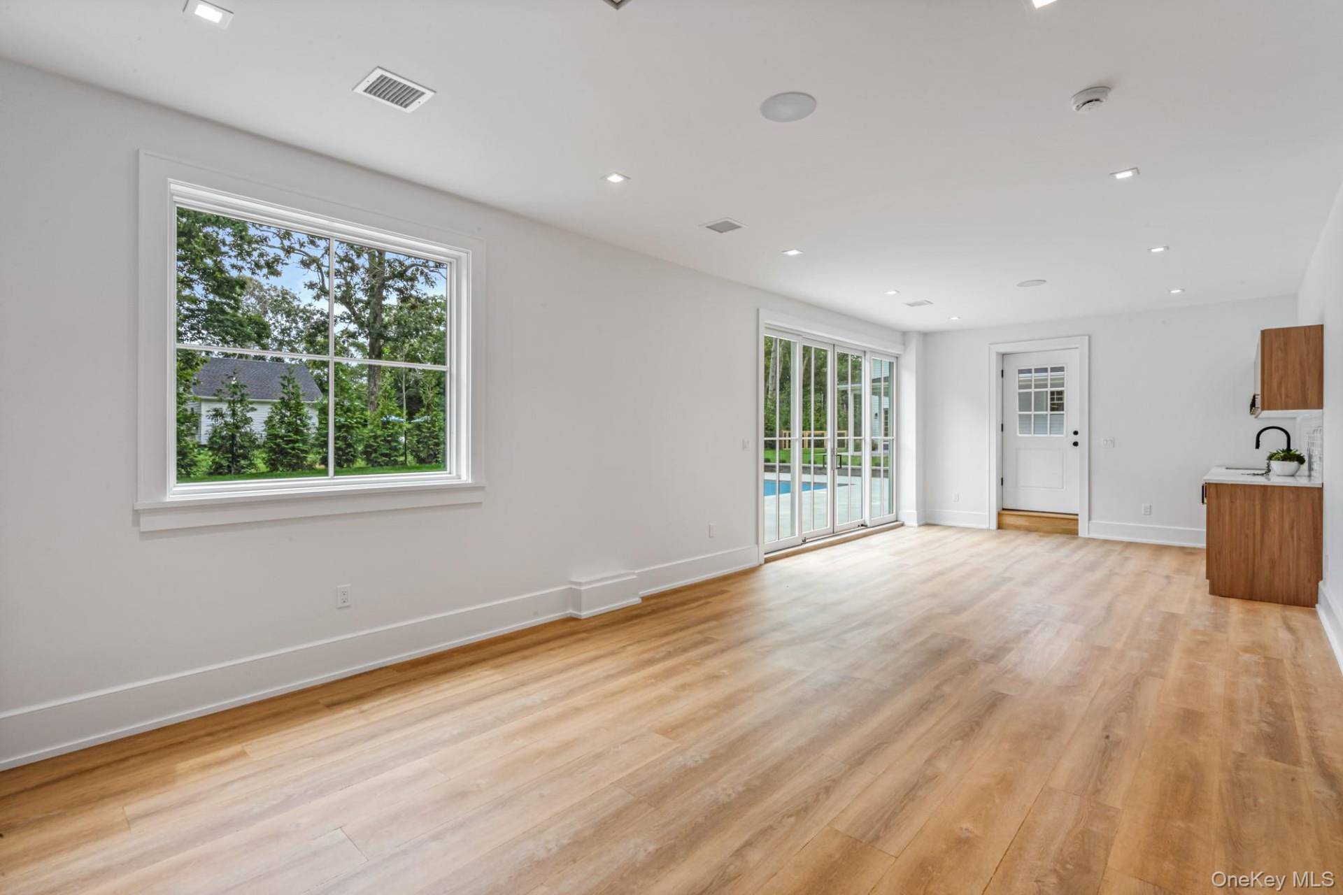 36 Jagger Lane Westhampton, NY 11977 - Photo 33 of 41 a view of an empty room with wooden floor and a window