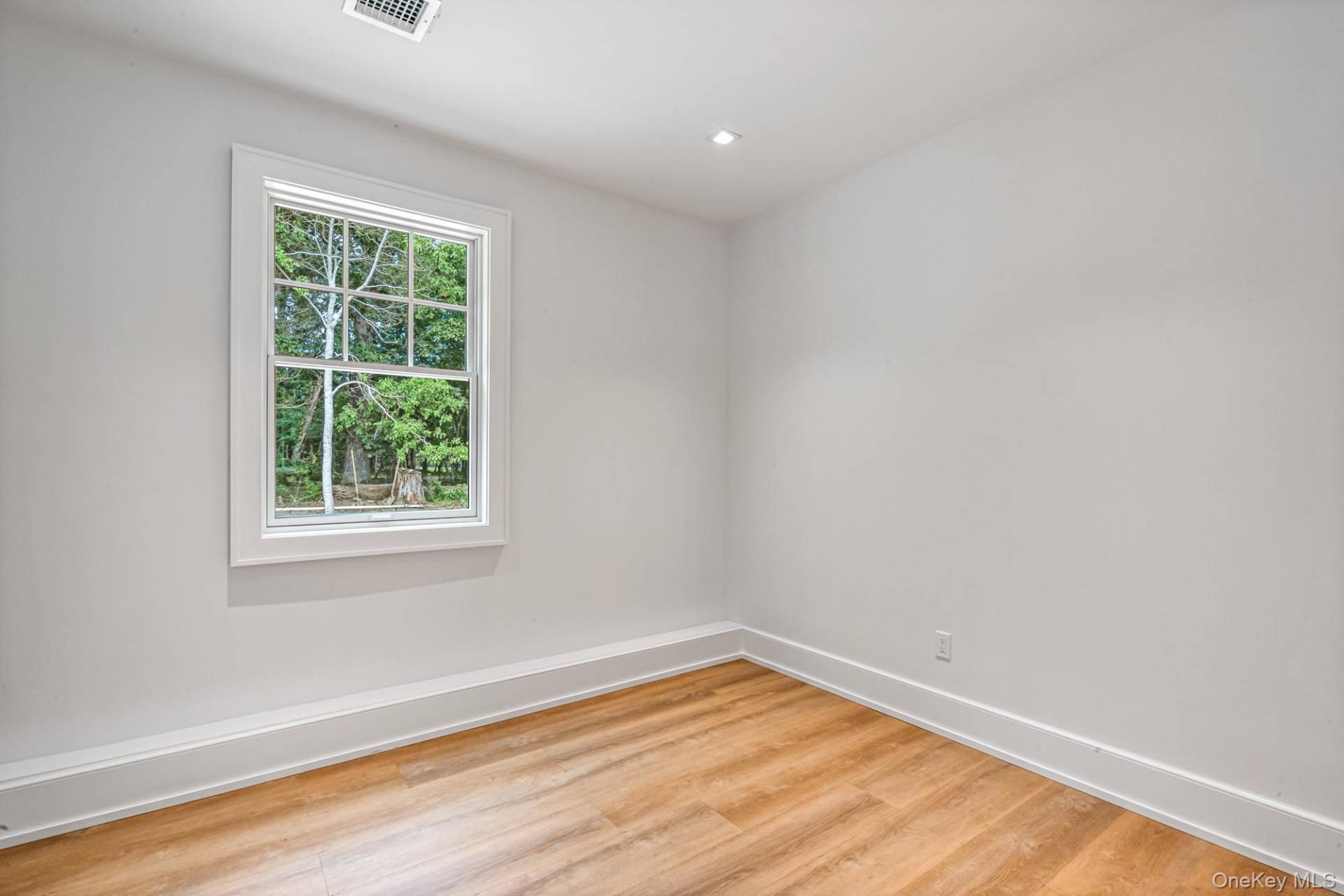 36 Jagger Lane Westhampton, NY 11977 - Photo 35 of 41 a view of empty room with wooden floor and fan