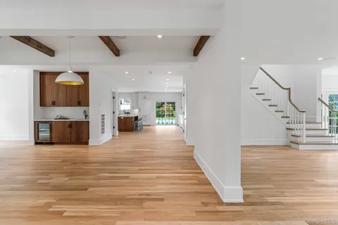a view of a living room kitchen with furniture and wooden floor