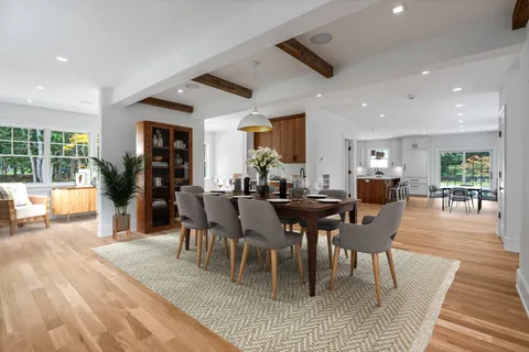 a view of a livingroom with wooden floor and stairs