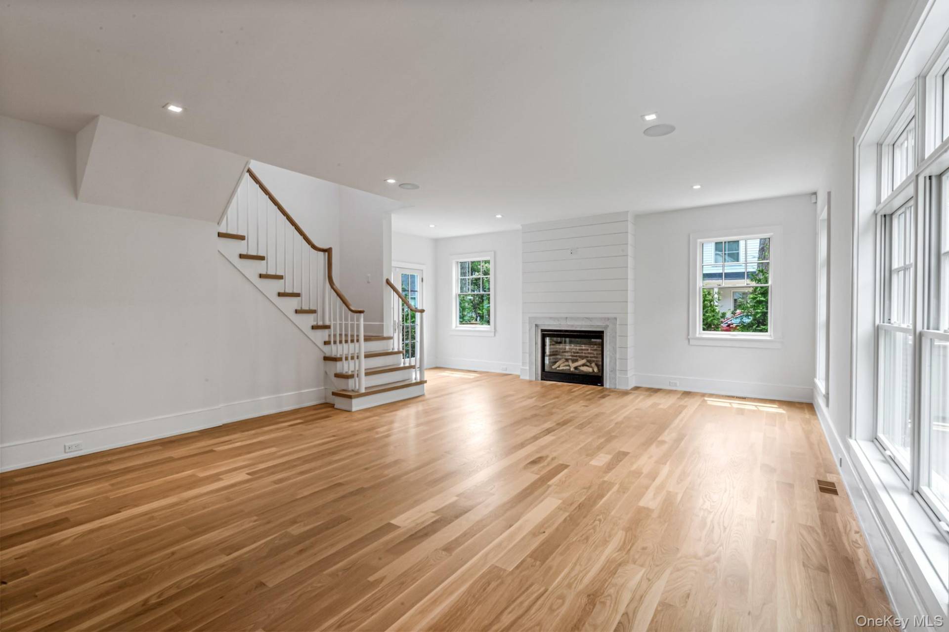 36 Jagger Lane Westhampton, NY 11977 - Photo 10 of 41 an empty room with wooden floor and fireplace