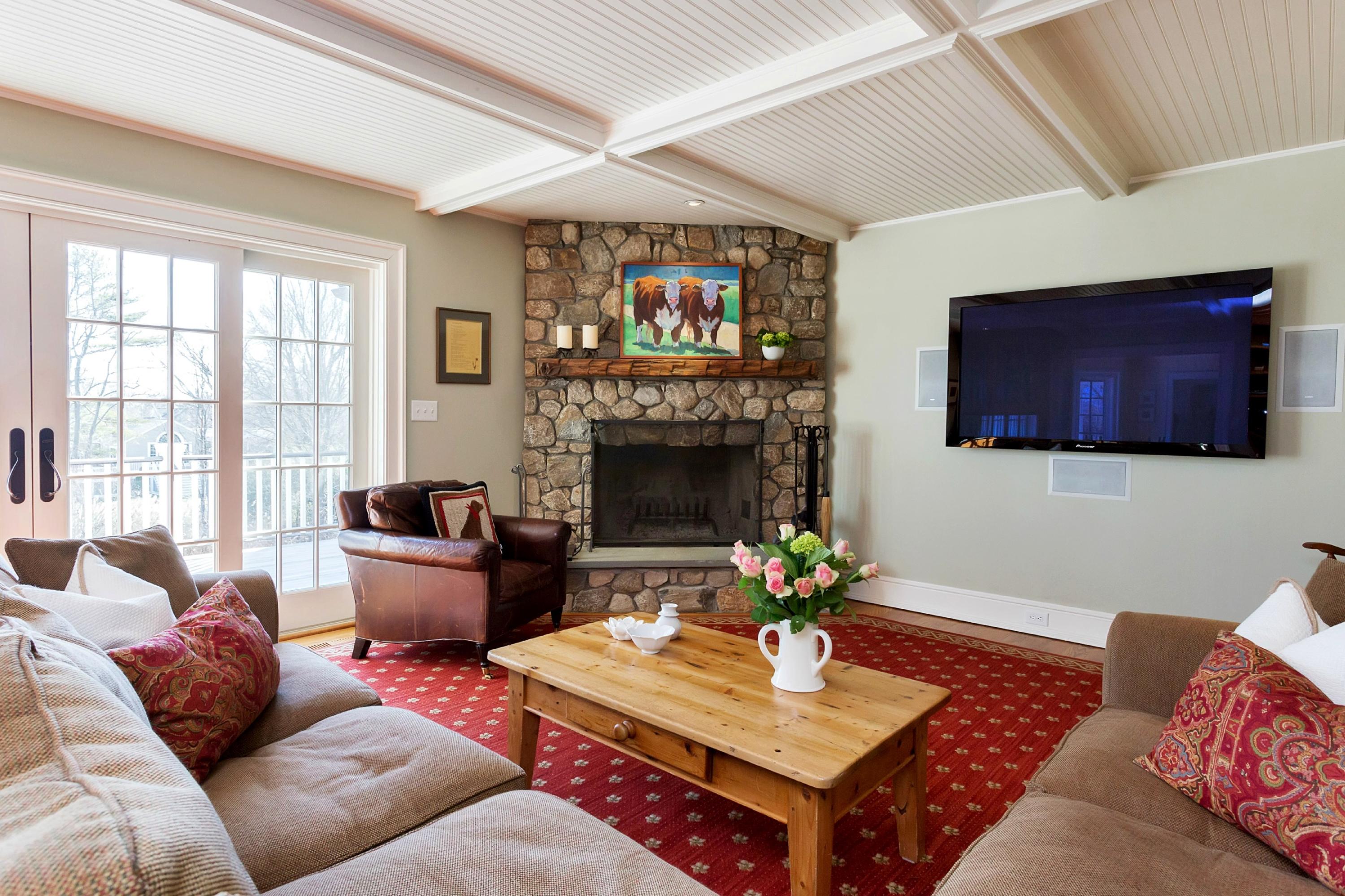 11 Juniper Road Darien, CT 06820 - Photo 11 of 25 a living room with furniture a fireplace and a flat screen tv