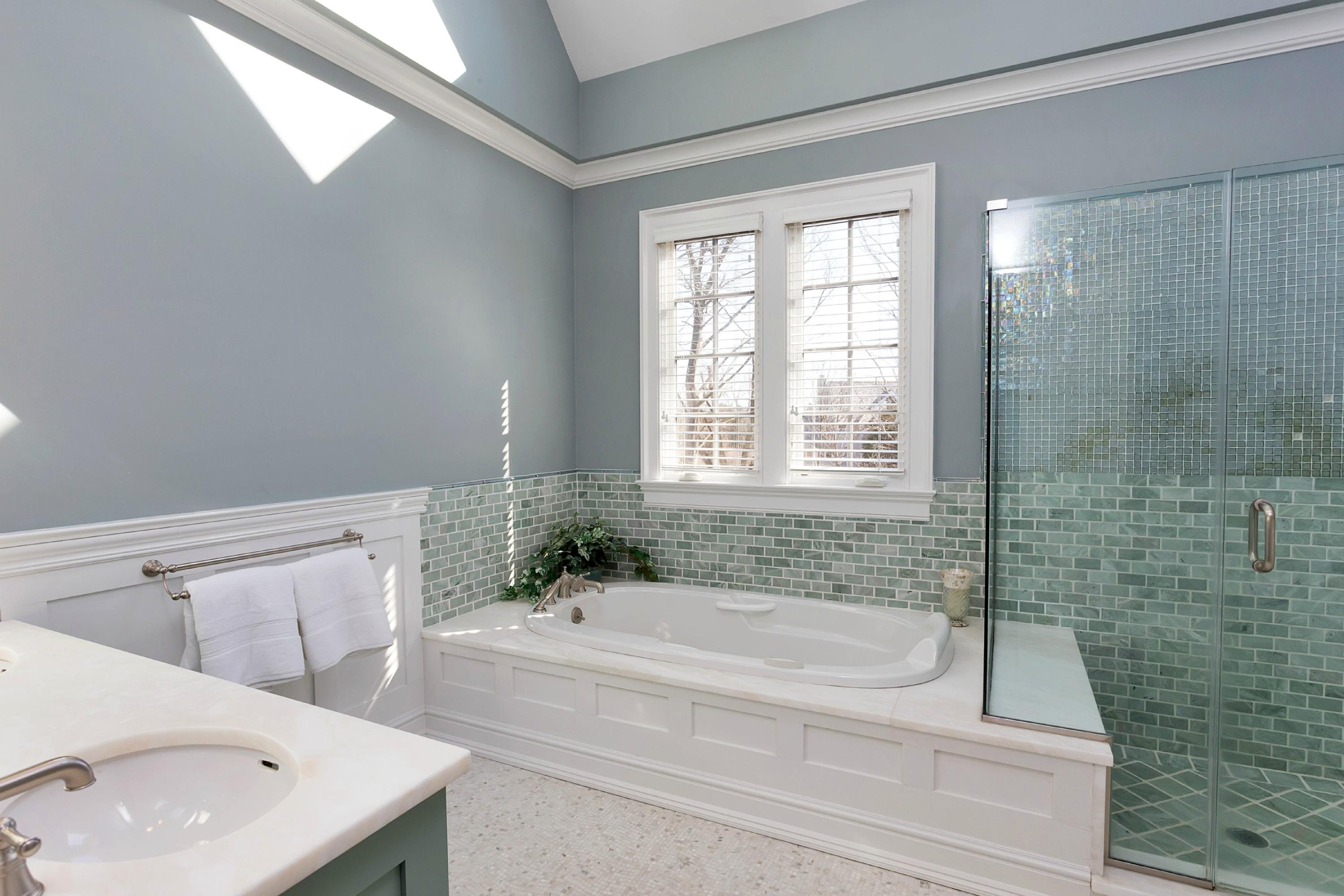 11 Juniper Road Darien, CT 06820 - Photo 15 of 25 a bathroom with a granite countertop sink a bathtub and shower
