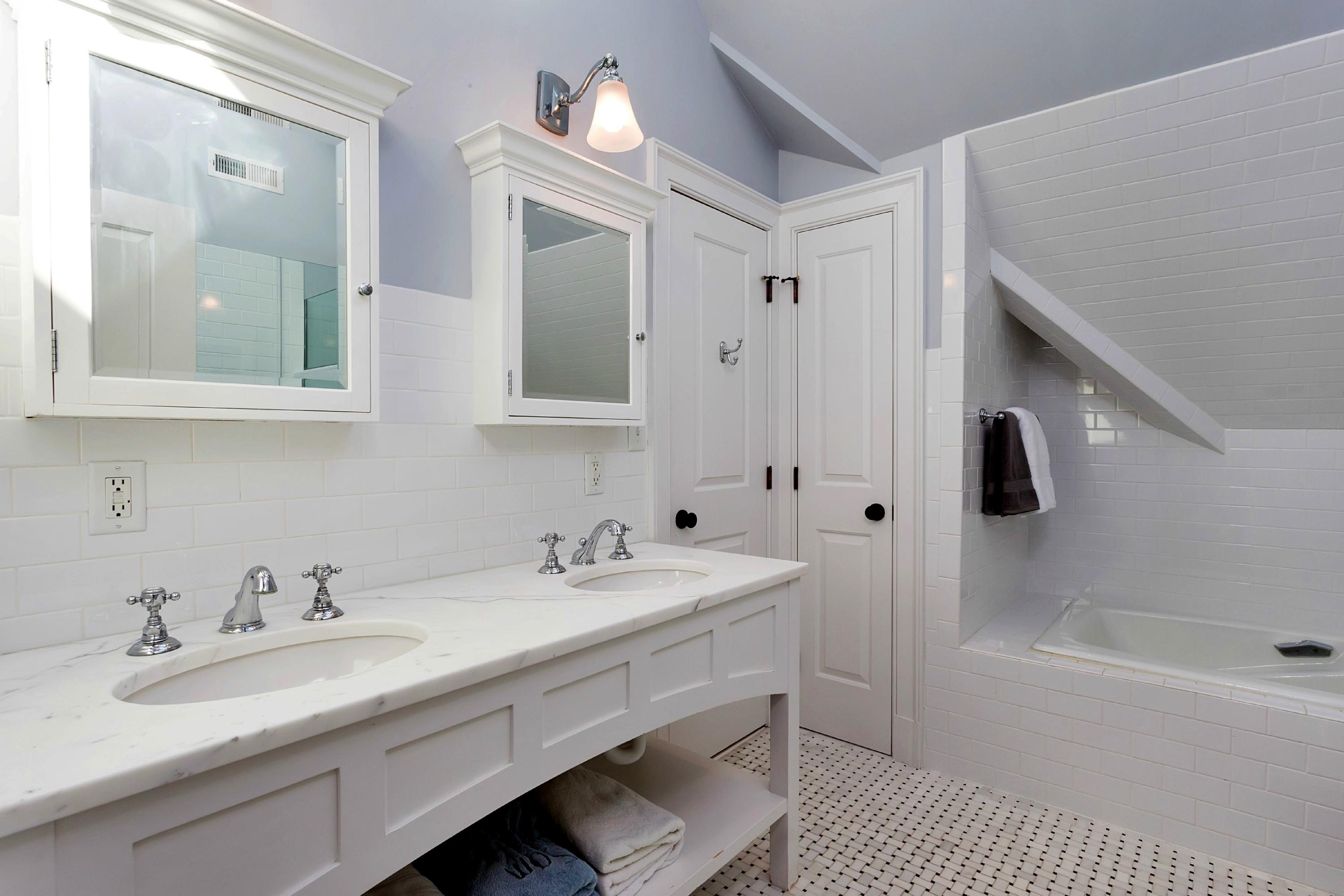 11 Juniper Road Darien, CT 06820 - Photo 20 of 25 a bathroom with a tub sink double vanity and mirror