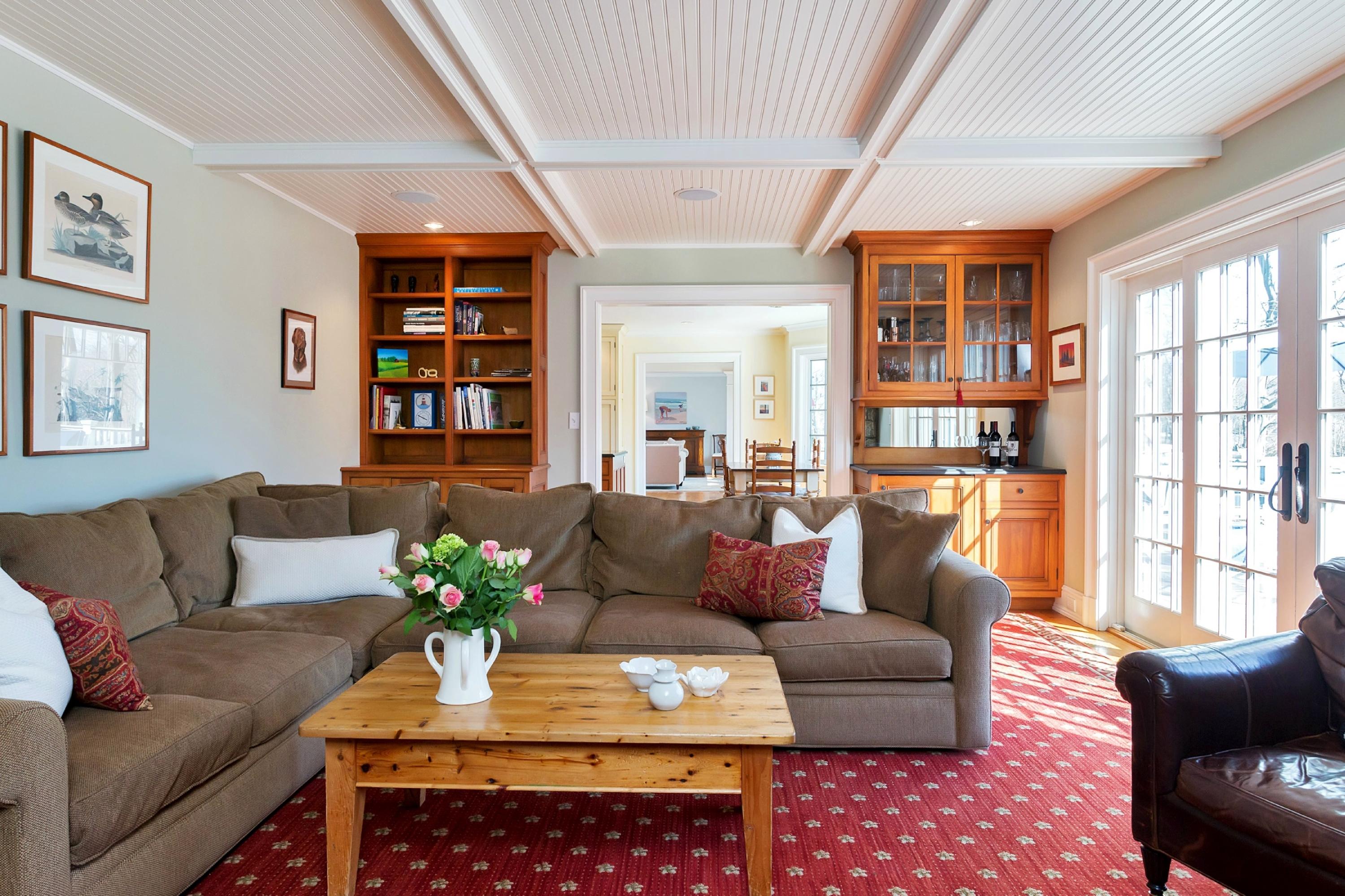 11 Juniper Road Darien, CT 06820 - Photo 10 of 25 a living room with furniture a bookshelf and a large window