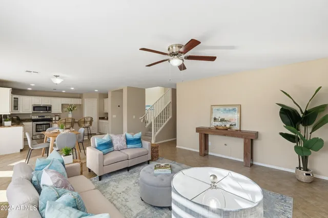 a living room with furniture and a potted plant