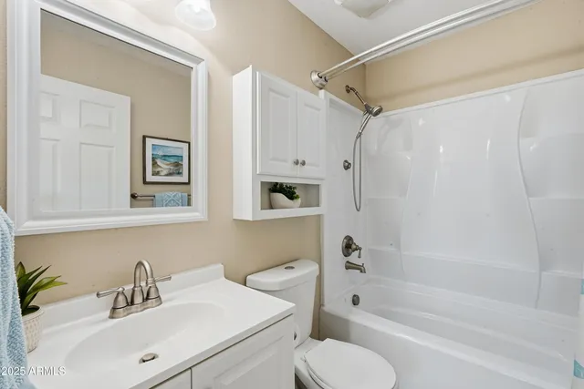 a bathroom with a sink toilet tub and shower