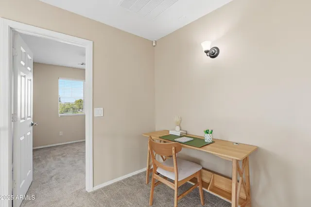 a view of a room that has a table and chairs in it