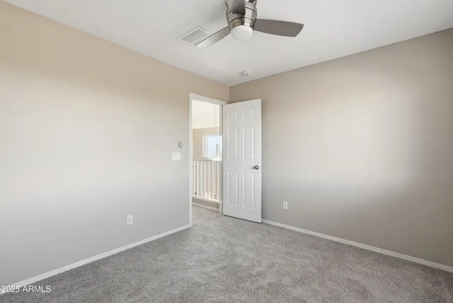 an empty room with a empty space and a ceiling fan