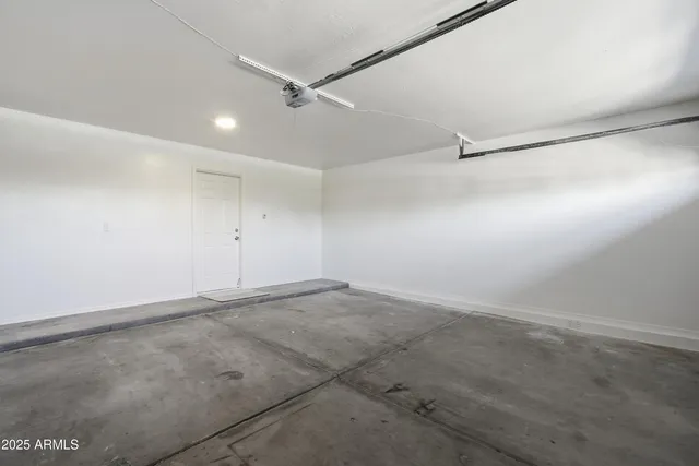 an empty room with ceiling fan and window