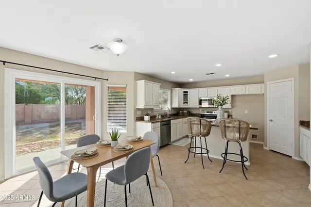 a dining room with furniture and window