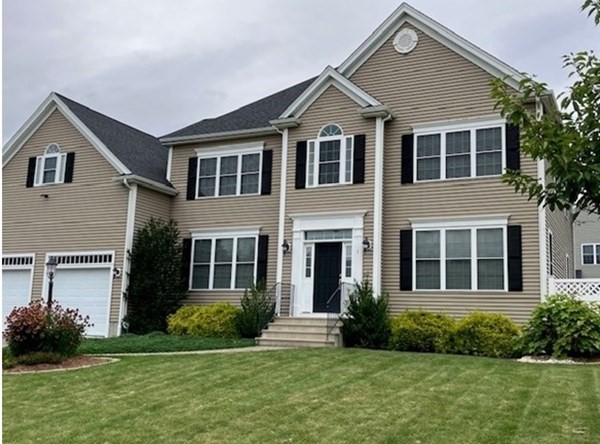 1 Ridgewood Street Ashland, MA 01721 - Photo 1 of 30 a front view of a house with a yard and garage