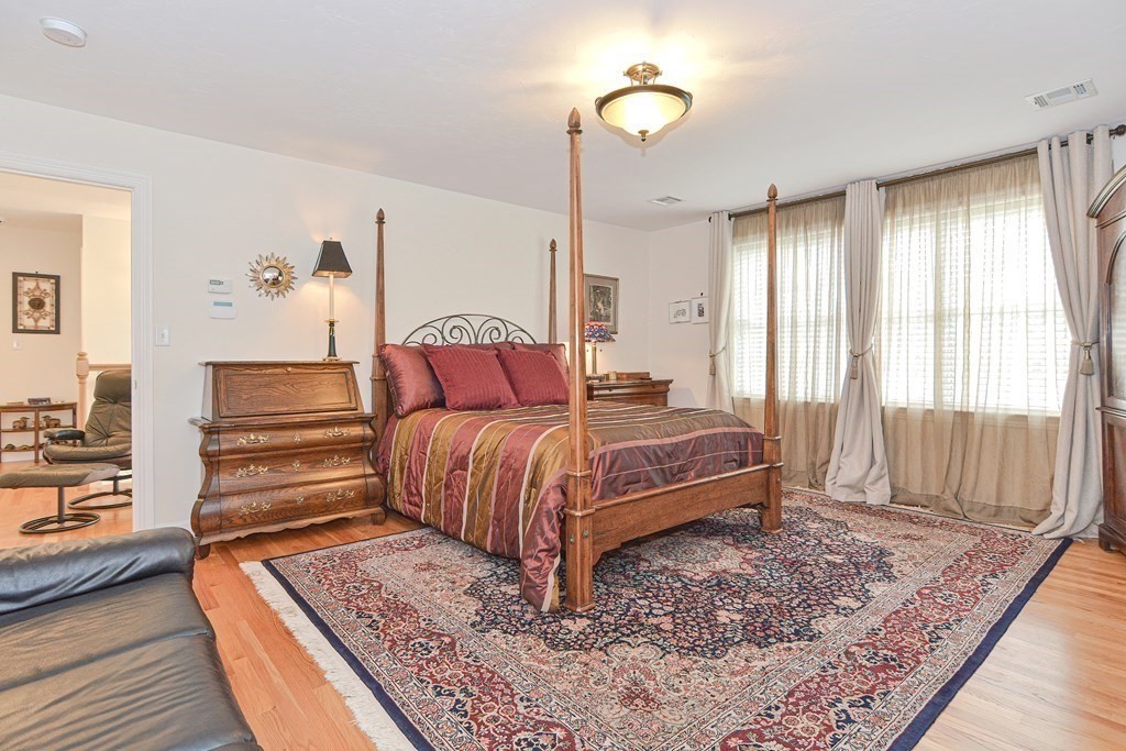 1 Ridgewood Street Ashland, MA 01721 - Photo 14 of 30 a bedroom with a bed and wooden floor