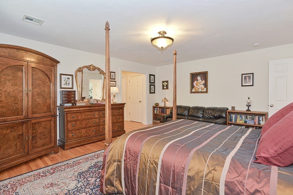 1 Ridgewood Street Ashland, MA 01721 - Photo 15 of 30 a bedroom with a bed dresser and wooden floor