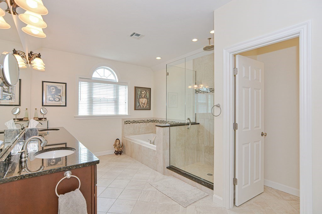 1 Ridgewood Street Ashland, MA 01721 - Photo 16 of 30 a spacious bathroom with a sink mirror and a bathtub