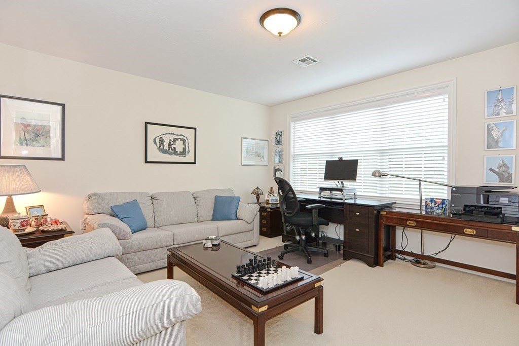 1 Ridgewood Street Ashland, MA 01721 - Photo 20 of 30 a living room with furniture a desk and a flat screen tv