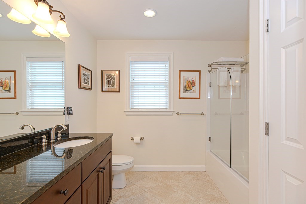 1 Ridgewood Street Ashland, MA 01721 - Photo 22 of 30 a bathroom with a granite countertop sink toilet and shower