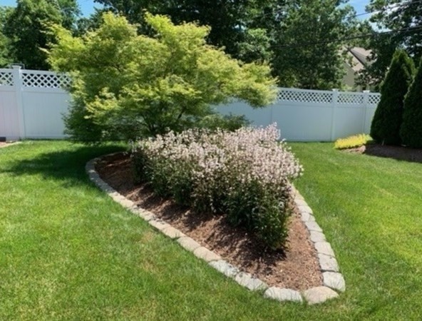 1 Ridgewood Street Ashland, MA 01721 - Photo 26 of 30 a view of a garden with a bench